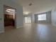 Living room with neutral paint, tile floor, a dining area, access to the kitchen, and a sliding door to the outside balcony at 2333 Feather Sound Dr # B104, Clearwater, FL 33762