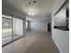 Spacious and bright living room with tile floors, neutral paint, access to a kitchen with updated appliances, and balcony at 2333 Feather Sound Dr # B104, Clearwater, FL 33762