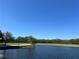 Picturesque water view of the golf course with clear blue skies, verdant greenery, and calm waters at 2333 Feather Sound Dr # B104, Clearwater, FL 33762