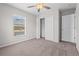 Cozy bedroom with carpet flooring, a ceiling fan, and closet for storage at 246 Castlekeeper Pl, Valrico, FL 33594