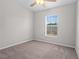 Bedroom featuring neutral carpet, ceiling fan, and natural light from the window at 246 Castlekeeper Pl, Valrico, FL 33594