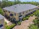 Aerial view of a multi-unit home featuring a landscaped lawn and a gray roof at 246 Castlekeeper Pl, Valrico, FL 33594