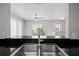 Kitchen sink overlooking living room with natural lighting at 246 Castlekeeper Pl, Valrico, FL 33594