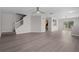 Bright living room featuring hardwood floors, a ceiling fan, and staircase to the second floor at 246 Castlekeeper Pl, Valrico, FL 33594