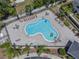 Aerial view of the community pool area with lounge chairs and landscaped surroundings at 246 Castlekeeper Pl, Valrico, FL 33594