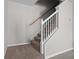 Carpeted staircase with white banister and wood handrail at 246 Castlekeeper Pl, Valrico, FL 33594