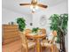 Dining area with wooden table, chairs, and a dresser, complemented by indoor plants at 2469 Franciscan Dr # 19, Clearwater, FL 33763