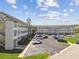 Low angle shot of the condo building showcasing its well-maintained exterior and dedicated parking area at 2469 Franciscan Dr # 19, Clearwater, FL 33763