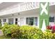 Well-maintained condo exterior featuring a balcony and vibrant landscaping at 2469 Franciscan Dr # 19, Clearwater, FL 33763
