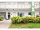 Close-up view of the condo's exterior entrance with well-manicured landscaping and clearly marked unit numbers at 2469 Franciscan Dr # 19, Clearwater, FL 33763