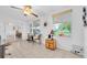 Bright living area with tile flooring, a ceiling fan, and views of the outdoor space at 2469 Franciscan Dr # 19, Clearwater, FL 33763