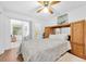 Bedroom with hardwood floors, ceiling fan, and a sliding door to the outside at 2469 Franciscan Dr # 19, Clearwater, FL 33763