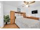 Bright bedroom featuring hardwood floors, ceiling fan, built-in storage, and a serene ambiance at 2469 Franciscan Dr # 19, Clearwater, FL 33763