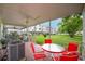 Back patio area with outdoor seating and a view of the grassy common area at 2469 Franciscan Dr # 19, Clearwater, FL 33763