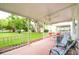 Relaxing screened-in patio area with outdoor seating and a view of the community green space at 2469 Franciscan Dr # 19, Clearwater, FL 33763