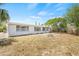Wide backyard features mature trees, a fire pit, and plenty of space for outdoor activities at 2616 Ohio Pl, Holiday, FL 34691