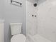 Sleek bathroom showcases a shower with modern tile, updated fixtures, and a white toilet at 2616 Ohio Pl, Holiday, FL 34691