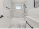 Nicely updated bathroom featuring tub and shower with modern fixtures and finishes at 2616 Ohio Pl, Holiday, FL 34691