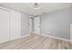 Cozy bedroom featuring wood-look flooring, closet, fresh paint, and modern ceiling fan at 2616 Ohio Pl, Holiday, FL 34691