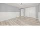 Bedroom featuring closet, wood-look flooring, neutral paint and white wainscoting at 2616 Ohio Pl, Holiday, FL 34691