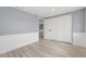 Clean bedroom featuring fresh paint, wood-look floors, closet, and neutral colors at 2616 Ohio Pl, Holiday, FL 34691