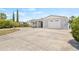 Charming home with a well-maintained front yard, circular driveway, and attached garage at 2616 Ohio Pl, Holiday, FL 34691