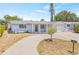 Charming single-story home featuring a covered entrance, attached garage, and meticulously maintained landscaping at 2616 Ohio Pl, Holiday, FL 34691