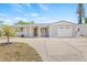 Exterior view of home, covered porch, and attached garage at 2616 Ohio Pl, Holiday, FL 34691