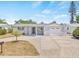 Exterior view of the home with a covered porch and well-maintained yard at 2616 Ohio Pl, Holiday, FL 34691