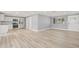 Spacious open concept featuring updated flooring flowing to the kitchen with modern appliances and finishes at 2616 Ohio Pl, Holiday, FL 34691