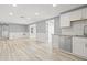 Spacious living room featuring modern wood-look flooring and neutral paint palette at 2616 Ohio Pl, Holiday, FL 34691