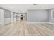 Open-concept living area with updated flooring seamlessly flows into the modern kitchen at 2616 Ohio Pl, Holiday, FL 34691