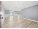 Expansive living room boasting recessed lighting, fresh paint, wainscoting, and attractive wood-look floors at 2616 Ohio Pl, Holiday, FL 34691