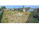 Back exterior view from the yard, showing perimeter fencing and building at 3422 Trask Dr, Holiday, FL 34691