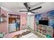 ' bedroom with pink walls and built-in closet provides ample storage and a cozy space for rest and play at 3422 Trask Dr, Holiday, FL 34691