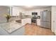 Modern kitchen with stainless steel appliances, granite countertops, and ample cabinet space at 3422 Trask Dr, Holiday, FL 34691