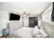 This main bedroom offers a fan, TV, hard surface flooring, and closet at 3422 Trask Dr, Holiday, FL 34691