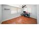 Home office with hardwood floors, a ceiling fan, and large windows at 3422 Trask Dr, Holiday, FL 34691