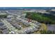 An aerial view showcases a vibrant community surrounded by lush greenery and serene ponds at 34780 Rainville Loop, Zephyrhills, FL 33541