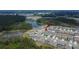 Areal view of residential neighborhood near lake and wooded area, showcasing access to recreation at 34780 Rainville Loop, Zephyrhills, FL 33541