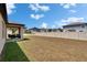 Home's backyard featuring a covered patio and ample space for outdoor activities at 34780 Rainville Loop, Zephyrhills, FL 33541