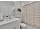 Stylish bathroom featuring a tub with a decorative curtain and a sleek, modern vanity at 34780 Rainville Loop, Zephyrhills, FL 33541