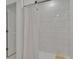 Bright bathroom with shower and white subway tile at 34780 Rainville Loop, Zephyrhills, FL 33541
