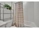 Clean bathroom features a white subway tile shower and convenient storage shelving at 34780 Rainville Loop, Zephyrhills, FL 33541
