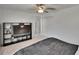 Neutral bedroom featuring a large TV, ceiling fan, carpet flooring, and a closet at 34780 Rainville Loop, Zephyrhills, FL 33541