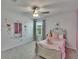 Inviting bedroom with grey carpet, natural light, and a wall mirror with ballerina-themed decals for charm at 34780 Rainville Loop, Zephyrhills, FL 33541
