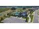 Aerial view of community pool featuring resort-style seating, lush landscaping, and adjacent playground at 34780 Rainville Loop, Zephyrhills, FL 33541