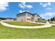 View of a well-maintained two-story home with a lush green lawn and attached garage at 34780 Rainville Loop, Zephyrhills, FL 33541