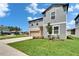 Charming two-story home boasts an attached garage and a well-manicured lawn at 34780 Rainville Loop, Zephyrhills, FL 33541