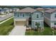 A charming two-story home featuring a well-maintained lawn and attached garage at 34780 Rainville Loop, Zephyrhills, FL 33541